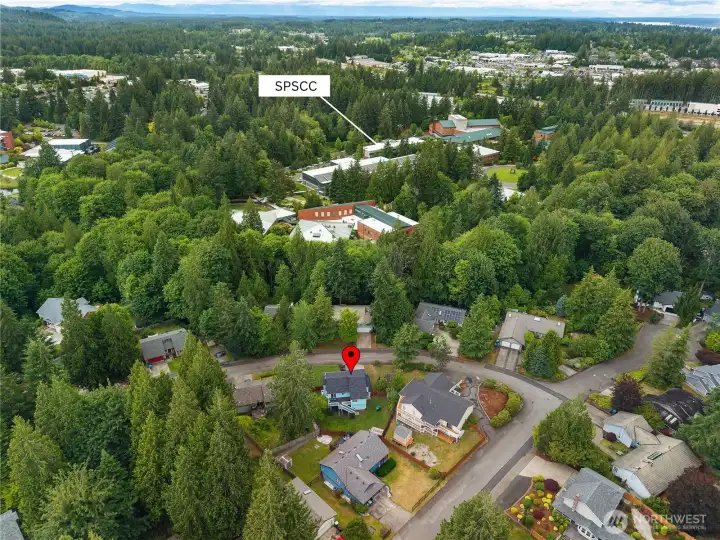 Aerial view highlights the home's peaceful setting and close proximity to South Puget Sound Community College and nearby services Aerial view highlights the home's peaceful setting and close proximity to South Puget Sound Community College and nearby services