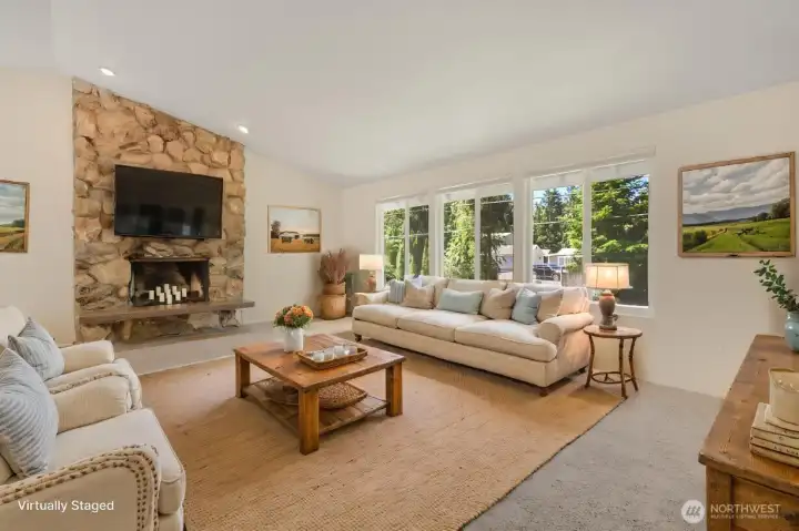 Living room with vaulted ceilings open to the dining room