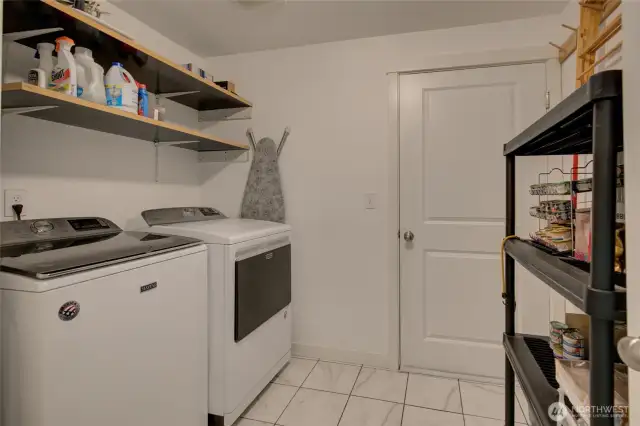 Huge mud-utility room leads to garage.
