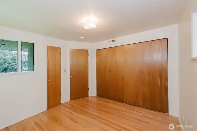 Closet space is thoughtfully integrated with sliding doors, providing practical storage while maintaining a clean and open feel.