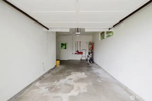 A deep, single-car attached garage provides both secure parking and space for tools, bikes, or a small workshop setup.