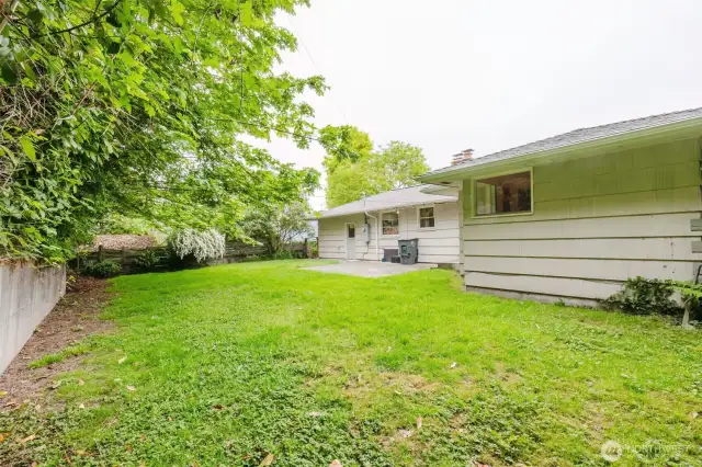 A gently sloped lawn provides ample space for pets, play, or gardening,