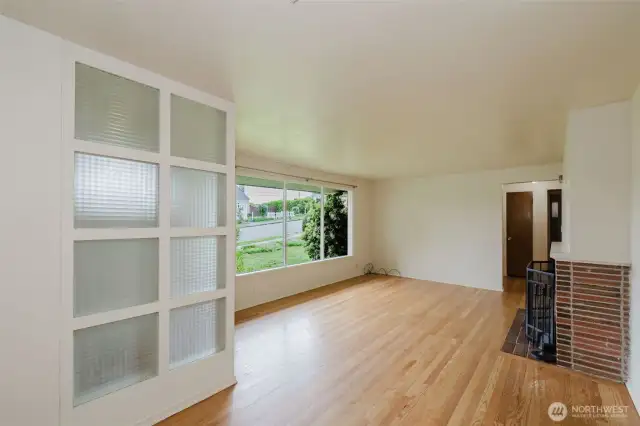 A built-in glass block partition adds a unique design element and gently separates the entry from the main living space while maintaining an open, airy feel.