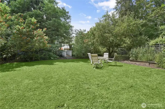 Talk about an awesome back yard. VERY PRIVATE with garden beds and razlberries