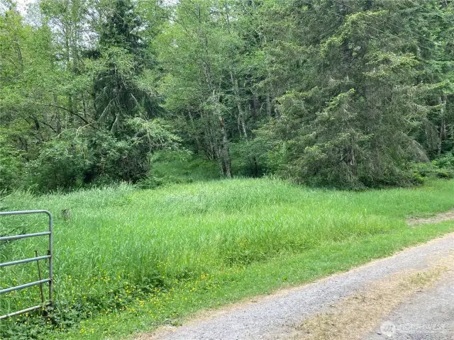 The property rises up a hill in the background.