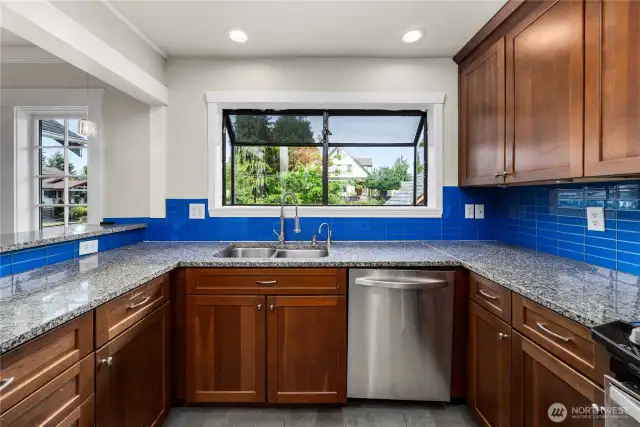 Light and bright kitchen looks out to dining room and living room.