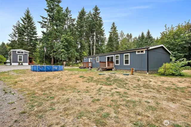 Back of home. 2 RV spots with hook up already set up!