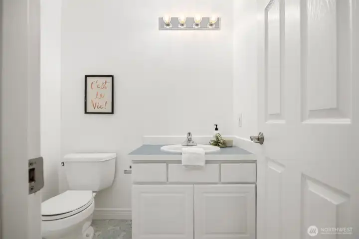 Half bath located off the laundry room adjacent to the garage.