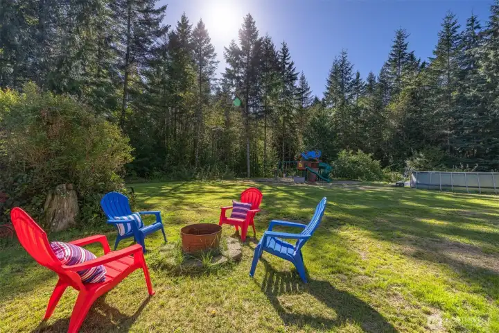 Surrounded by tall, mature evergreens with an abundance of cleared lawn, the yard is the space of dreams.