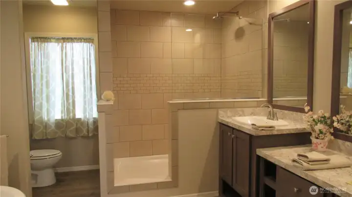 Primary Bathroom with double sinks and tiled walk in shower