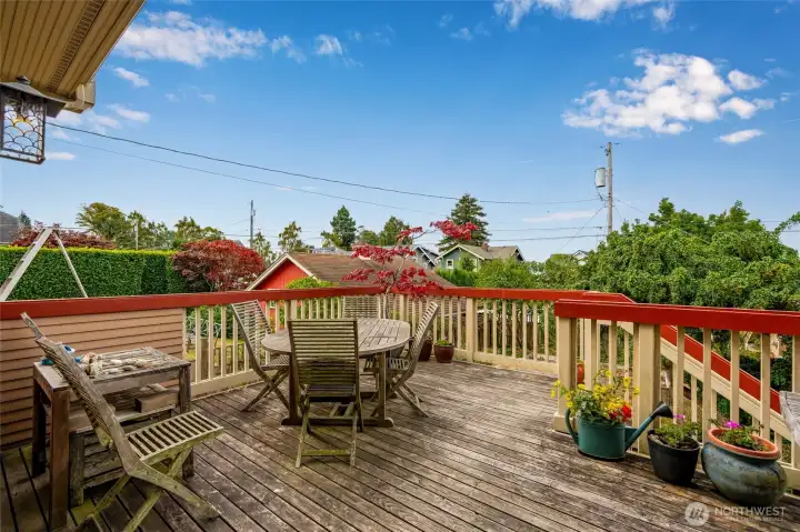 Deck off the kitchen overlooks the backyard, Puget Sound, and the surrounding neighborhood — ideal for outdoor dining and relaxing.