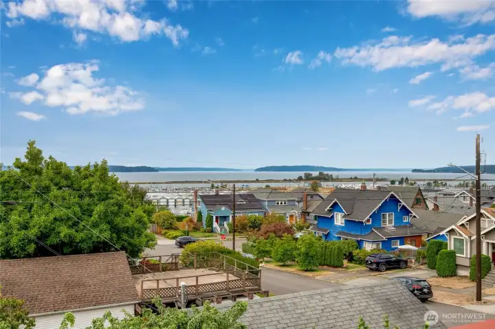 Breathtaking views of the Puget Sound, marina, and Jetty Island as seen from the primary suite windows — views that make this home truly special.
