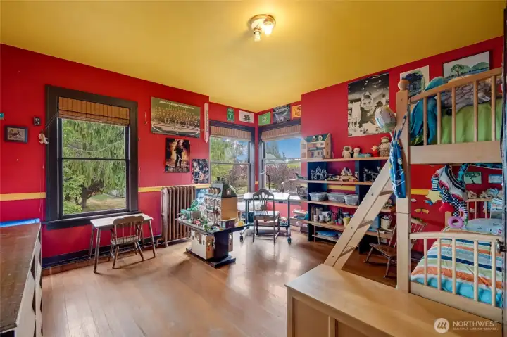 Third oversized bedroom with hardwood floors, large windows with abundant natural light, and generous space.