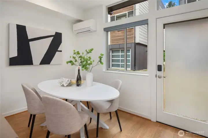 Full sized dining area just off the kitchen with overhead mini-split providing heat and A/C. The door leads to the dedicated parking spot just outside.