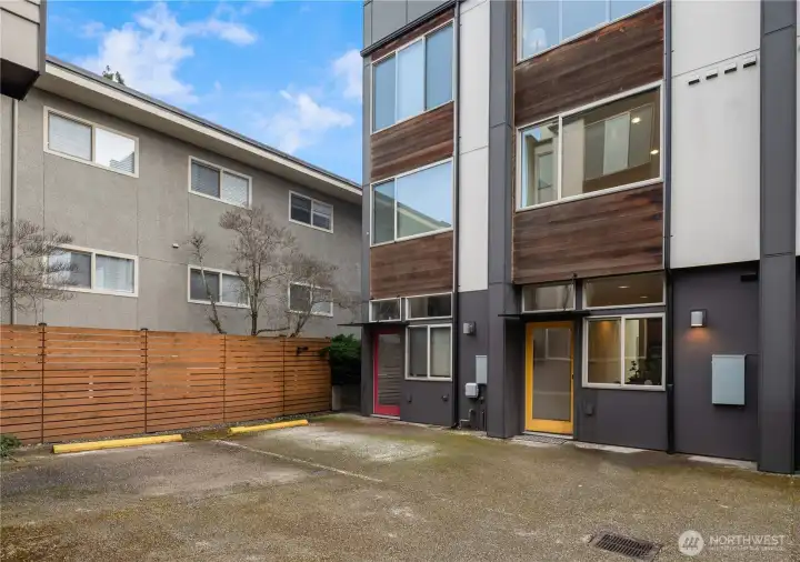Just off the yellow back door is this dedicated parking space on the left for easy in-and-out unlike some super tight townhouse parking areas.