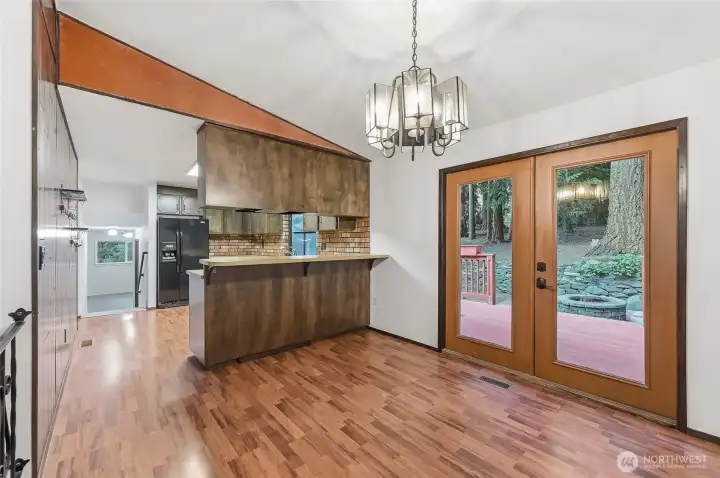 Dining room shot off the deck to a spacious back yard