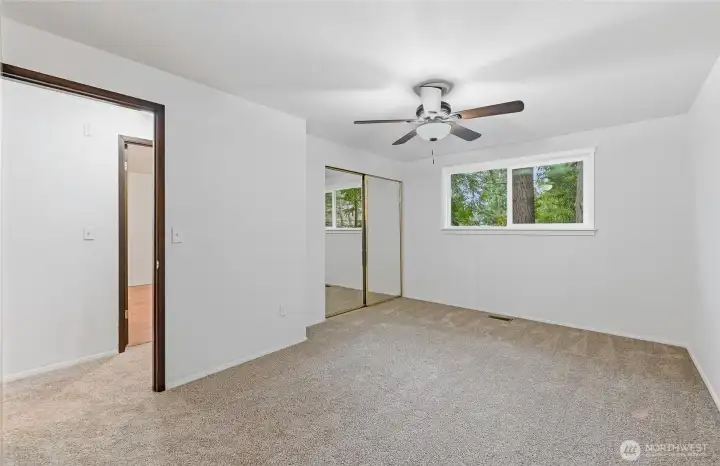 Primary Bedroom with new carpet, fresh paint and new window.
