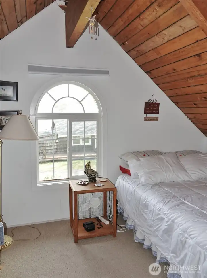 Upstairs 2nd Bedroom w/ vaulted wood ceilings.