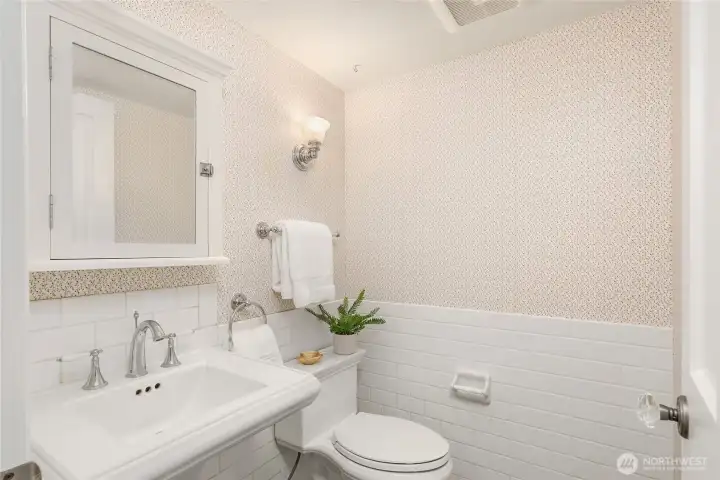 Powder room/ half-bathroom conveniently located between entry and kitchen.