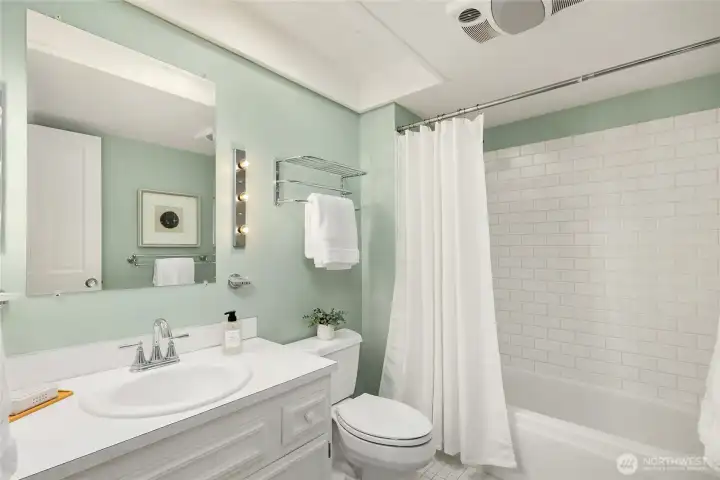 Guest Bath (Full) with tile surround and tile flooring.