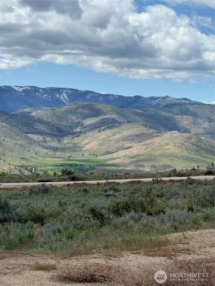 Property extends beyond the road on each side of the property.