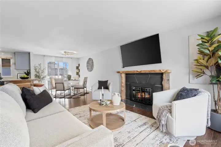 Cozy light filled living room with electric fireplace.