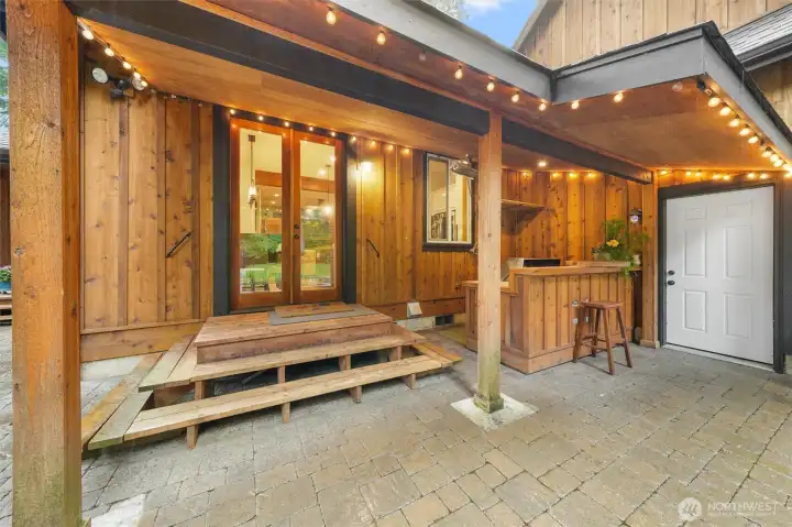 Exterior view of outdoor kitchen area and covered entrance into dining area. Exterior view of outdoor kitchen area and covered entrance into dining area.