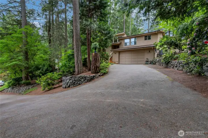 Ample parking with garage, driveway and turnaround to the right.