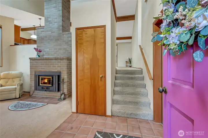 Living room with fireplace is on main floor and open to living space above.