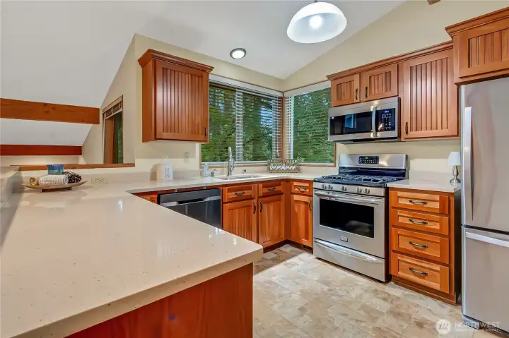 Kitchen updated in 2013 with gas stove and stainless steel appliances.