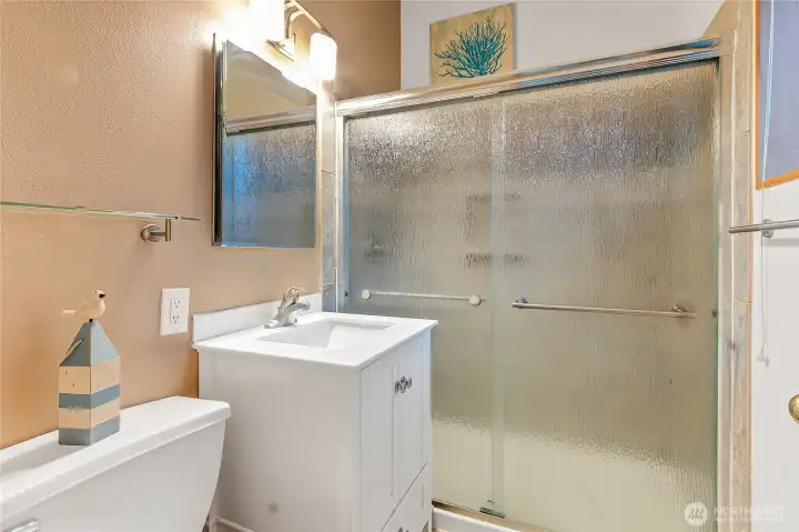 Primary bath with walk in shower.  Under cabinet storage is very spacious too.