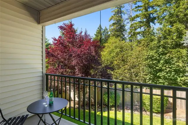 Tranquil balcony overlooks greenbelt