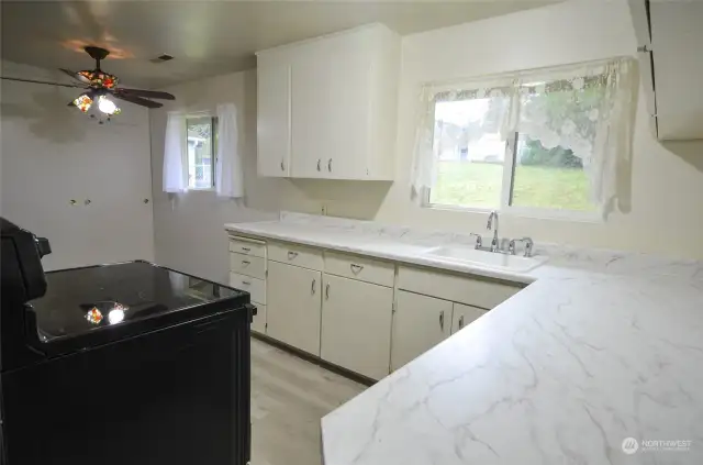 Walk-around kitchen with new counter-tops. Clean and cheery