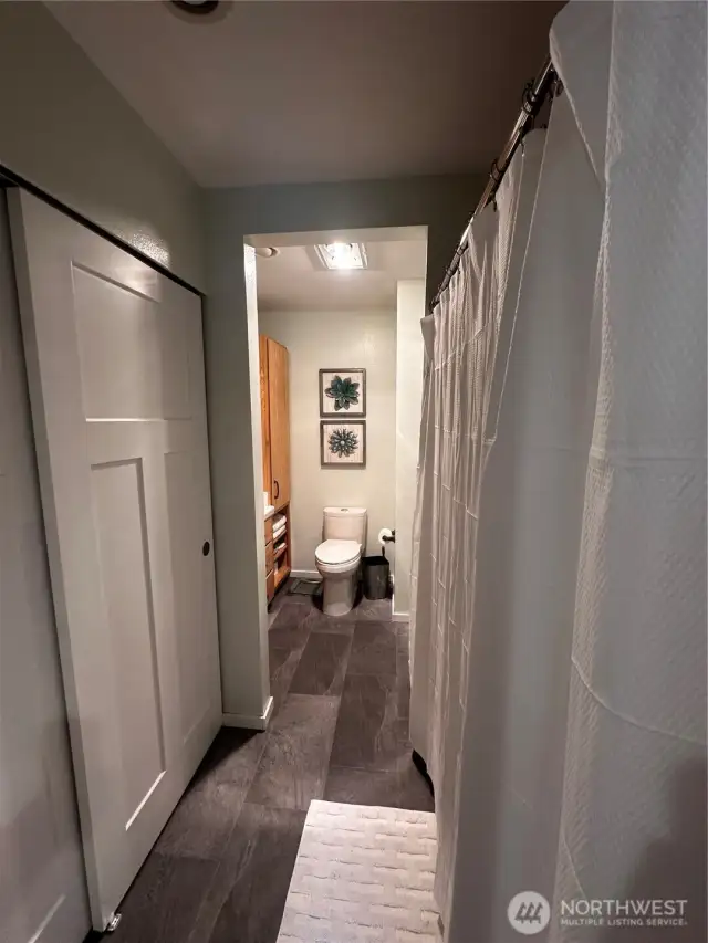 Looking from the 2nd bedroom into the full hallway bath through the bedroom entrance.