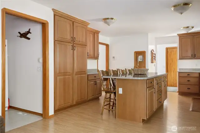 View from family room (with fireplace) into kitchen and laundry room on left