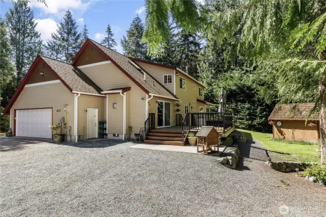 Lots of parking space, 2-car garage and back deck with hot tub and playhouse/storage