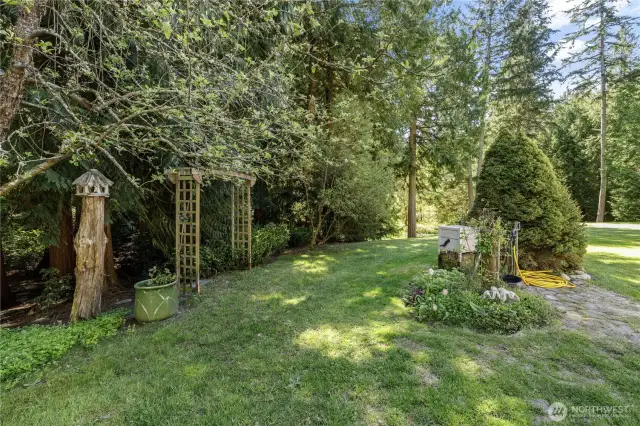 Entry to the trail that leads to the enclosed garden with mature apple trees and lilacs.