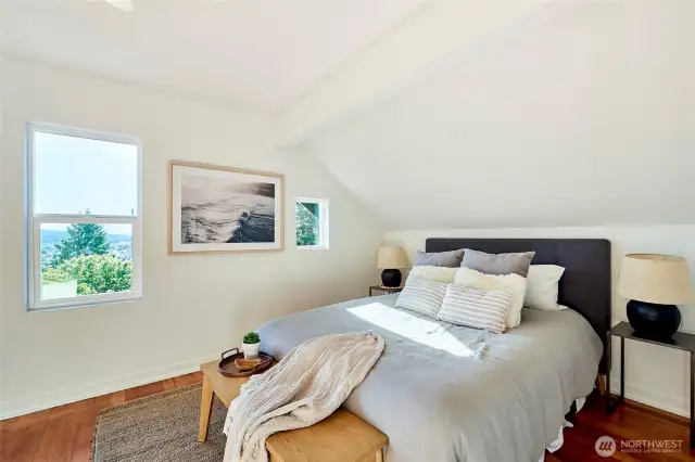 Primary bedroom with original fir flooring and en-suite and oversized closet.