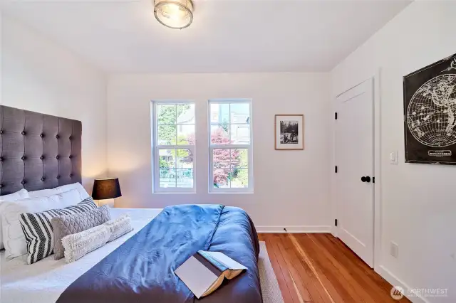 One of 3 upper floor bedrooms featuring refinished original fir floors.