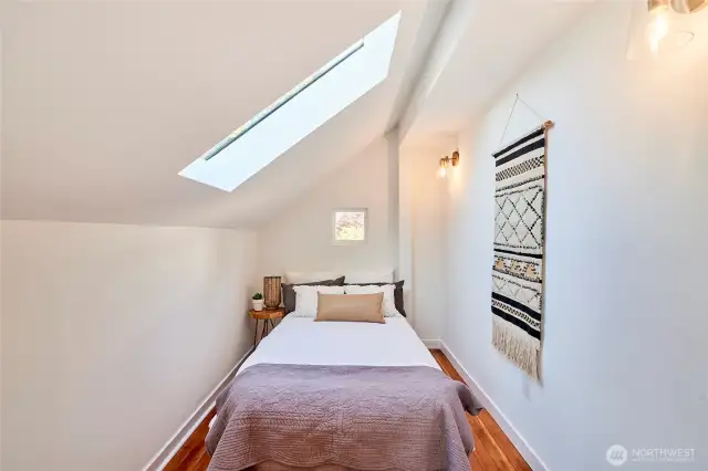 Charming 3rd bedroom with tons of natural light and original fir flooring.