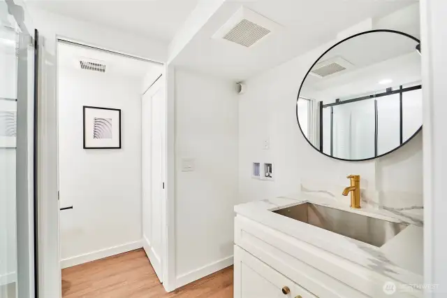 Bath with quartz counters and w/d hookups is one of two lower levels bathrooms.