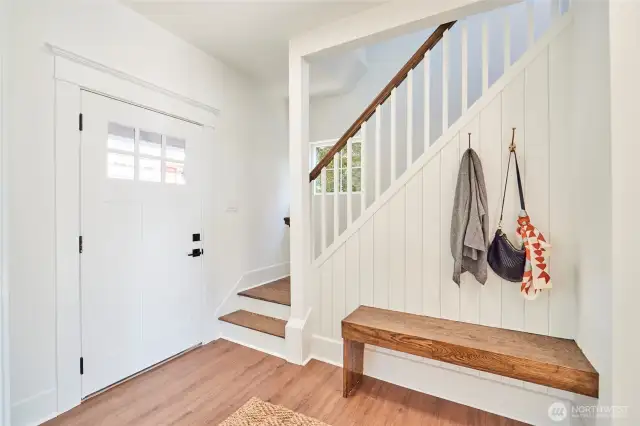 Delightful entryway with custom floating bench.