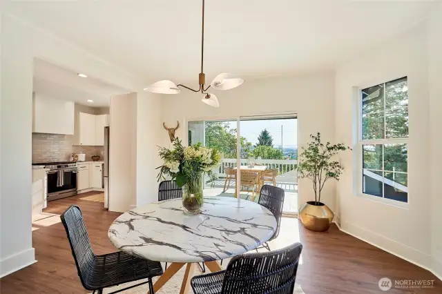 Sprawling dining room with stylish finishes opens to sun-filled deck overlooking sunset and Cascade Mountain views.