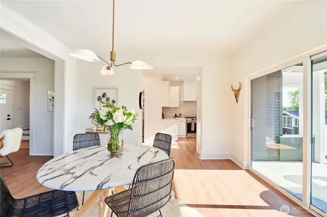 Sprawling dining room with stylish finishes opens to sun-filled deck overlooking sunset and Cascade Mountain views.