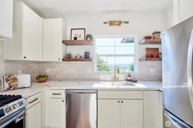 Tons of light flood kitchen with the western views of the mountains and Ballard.