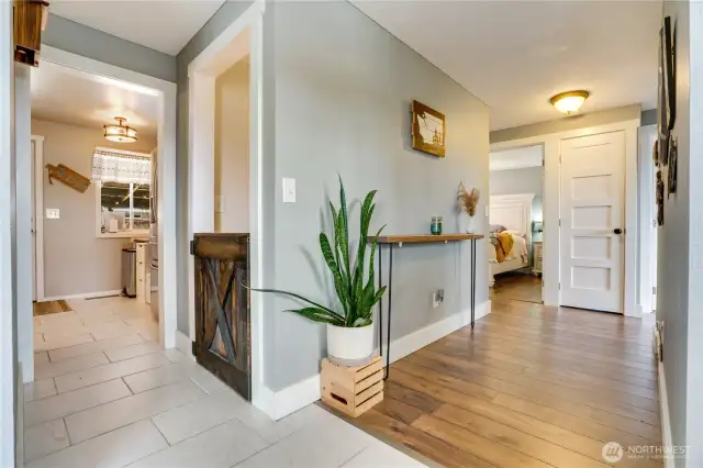 Step inside to a welcoming tile entry, where rich upgraded millwork, stylish doors, and polished hardwood floors set a sophisticated tone for this stunning home.