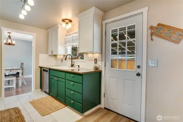 The step-saver kitchen, with its sleek design, offers seamless access to the covered patio and backyard, ideal for effortless entertaining and outdoor chilling.