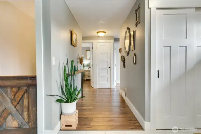 A trendy barn-style door opens to the finished basement.