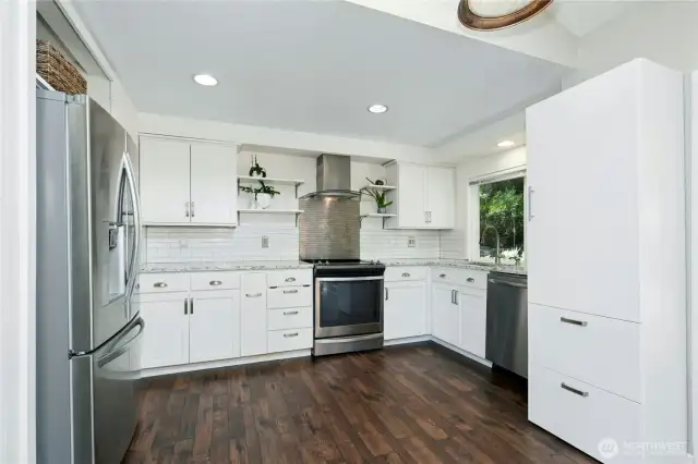 Updated kitchen with movable island and Stainless-Steel appliances