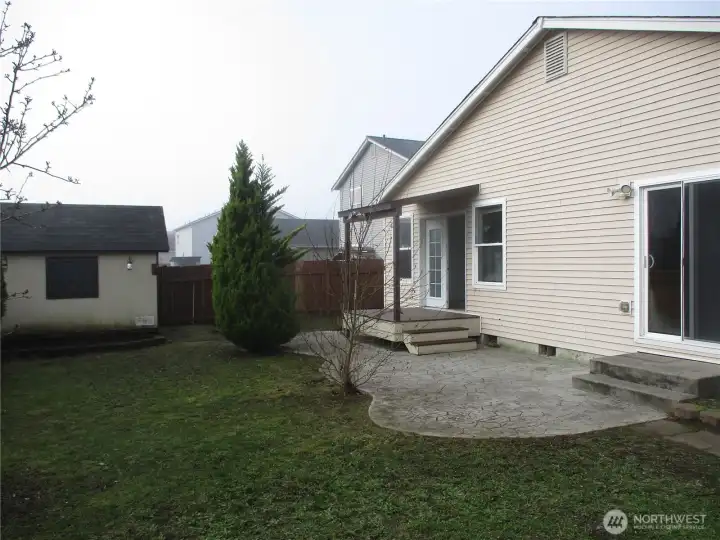 Back yard with patio off the primary bedroom.